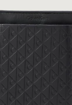 Calvin Klein EMBOSSED EMBLEM PHONE CROSSBODY - Phone Pouch - Black -Stock X 652943bffed9406389474b45bb43aa0b
