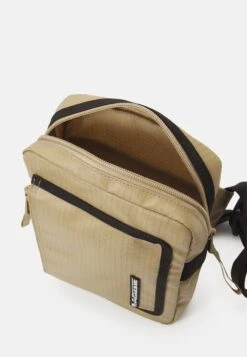 Lacoste Street Balance Unisex - Across Body Bag - Lion Noir -Stock X 67fb0a3597e744fab6897c711c4e0a3c