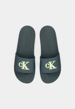 Calvin Klein Jeans SLIDE MONO - Mules - Seaside Aqua/white -Stock X 7368c43944434fc7873678e6bee0aae4