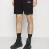 Café Croissant Unisex - Shorts - Black -Stock X 7bd77ec494f740ca9403d2134eb7a4e2