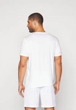 Puma ESSENTIALS SOLID CAT TEE - Sports T-shirt - White -Stock X b603d23bbee74f9587c7709bb60d38cf