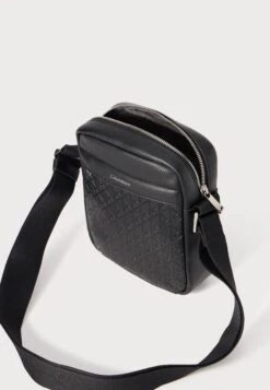 Calvin Klein EMBLEM EMBOSS REPORTER - Cross Body Bag - Black -Stock X c54e12a7ba79455680ae2257936b0d4c