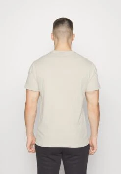 NEW ERA Nfl Generic Logo Nfl Shield Graphic Tee - Print T-Shirt - Offwhite -Stock X ff0325fa648a4fee8934b56a7beefefa